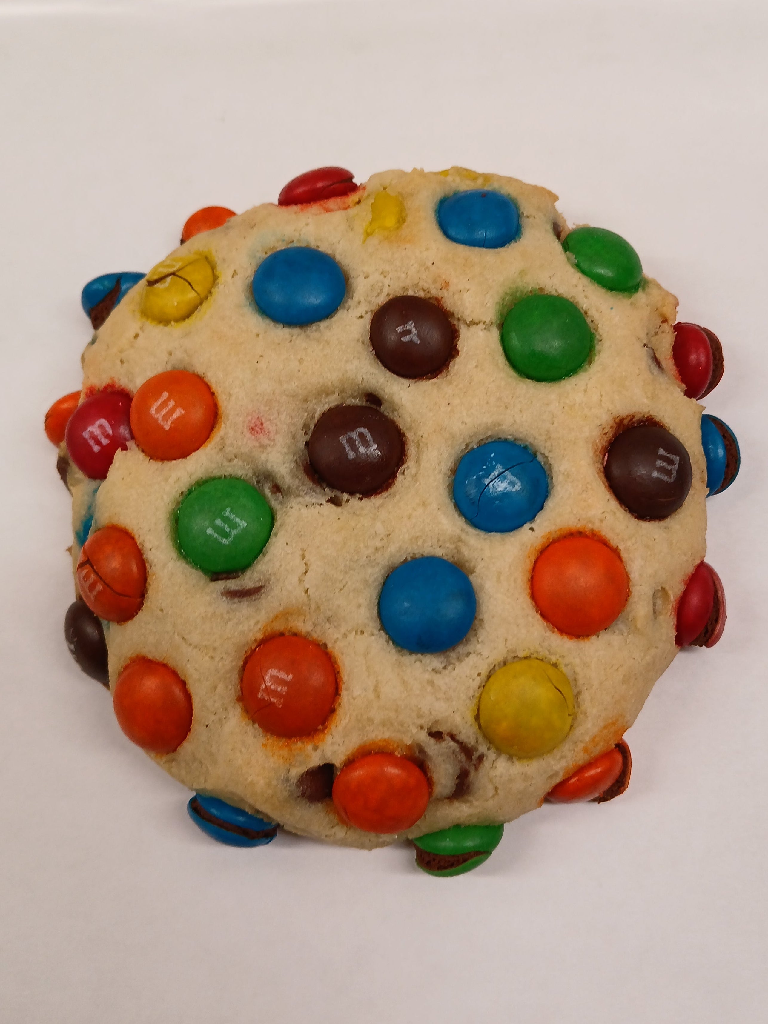 GF Cookie with colorful M&M candies on a white surface