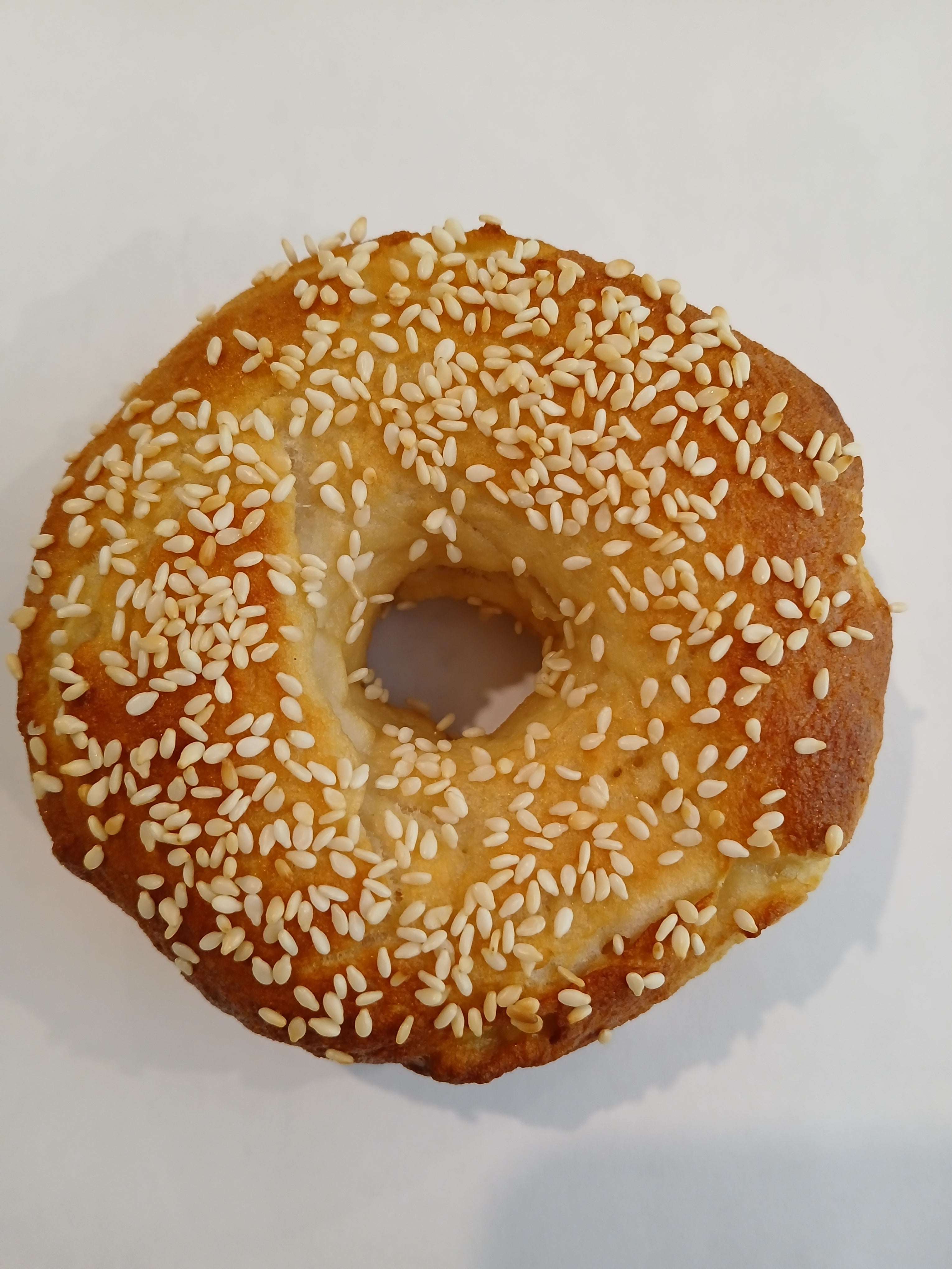 Sesame seed bagel on a white background gluten free