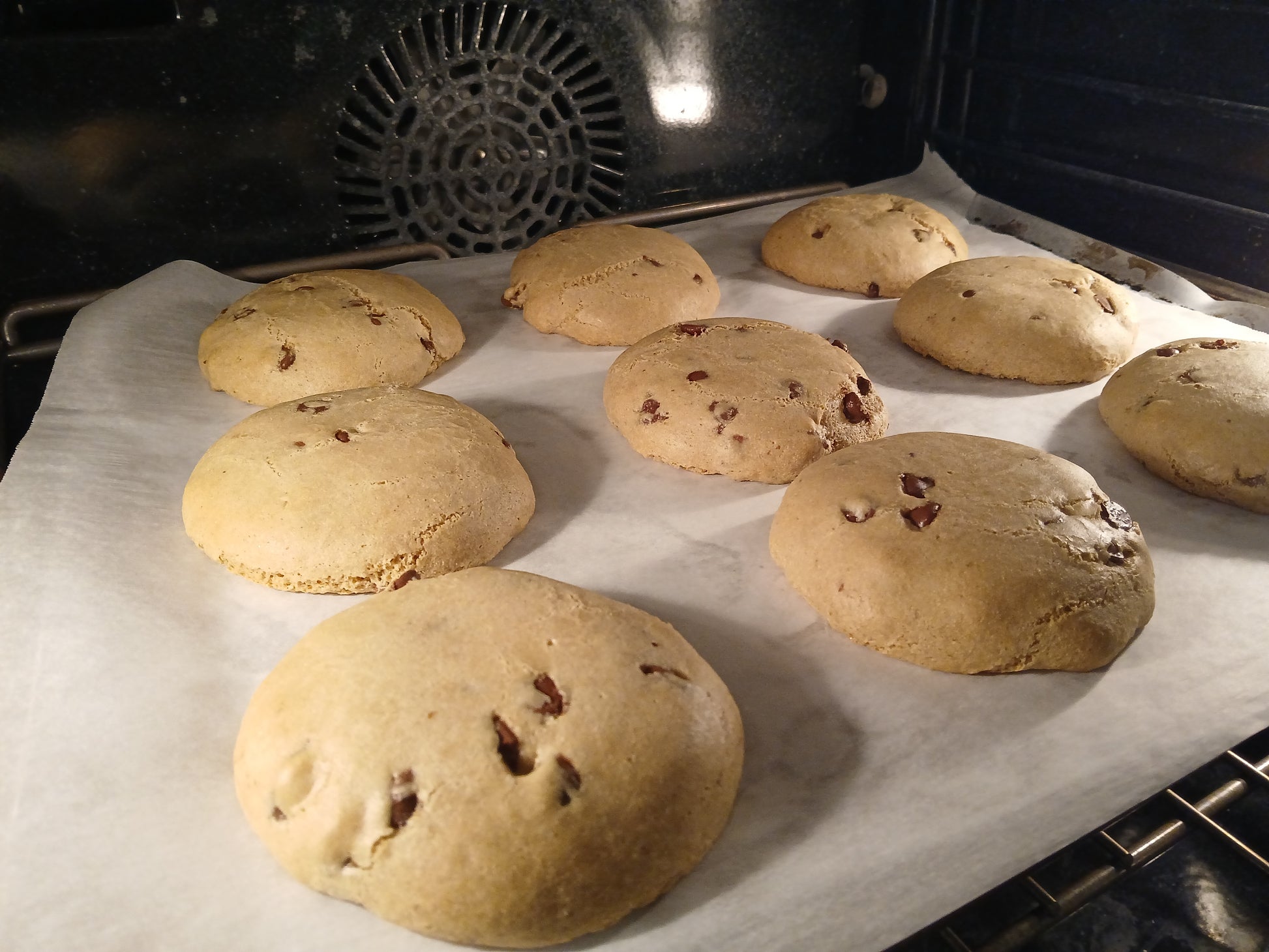 Baked cookies on a baking sheet inside an oven