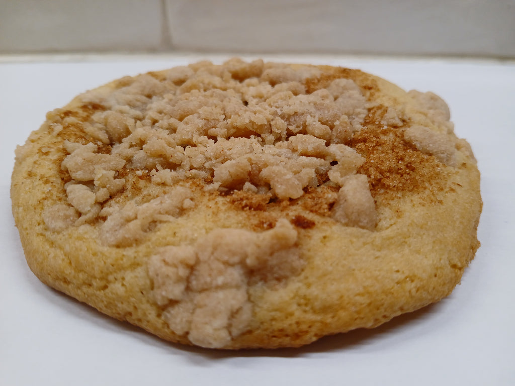 Round GF cookie with crumbly topping on a white surface