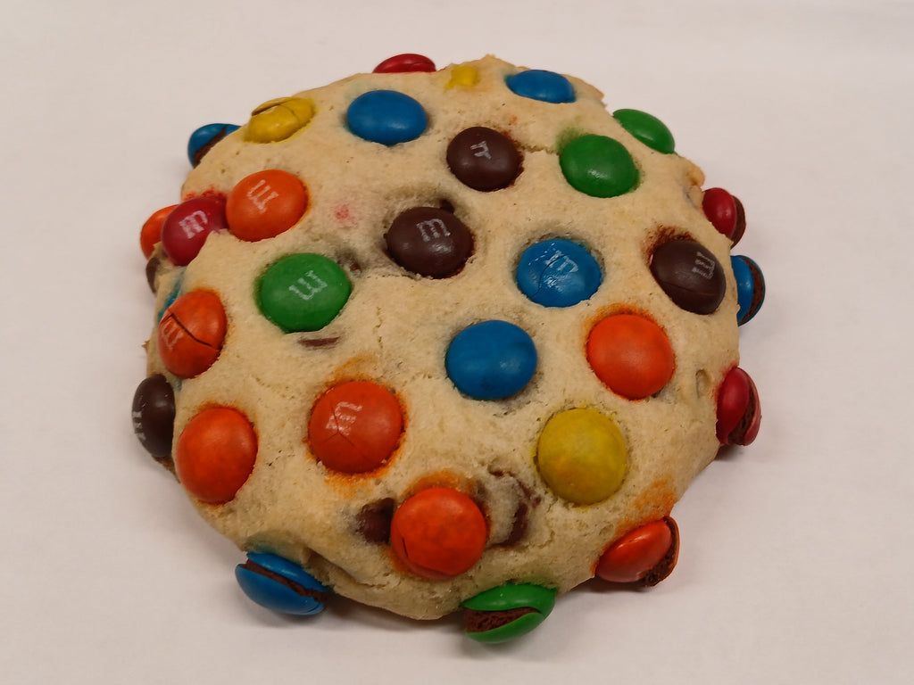 GF Cookie with colorful M&M candies on a white surface