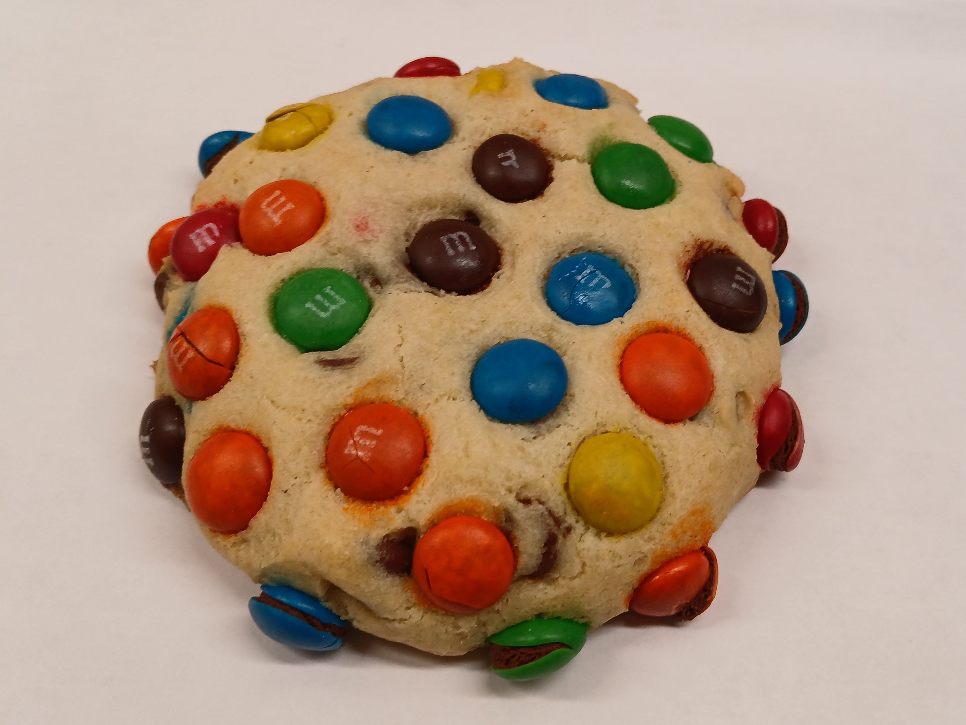 GF Cookie with colorful M&M candies on a white surface