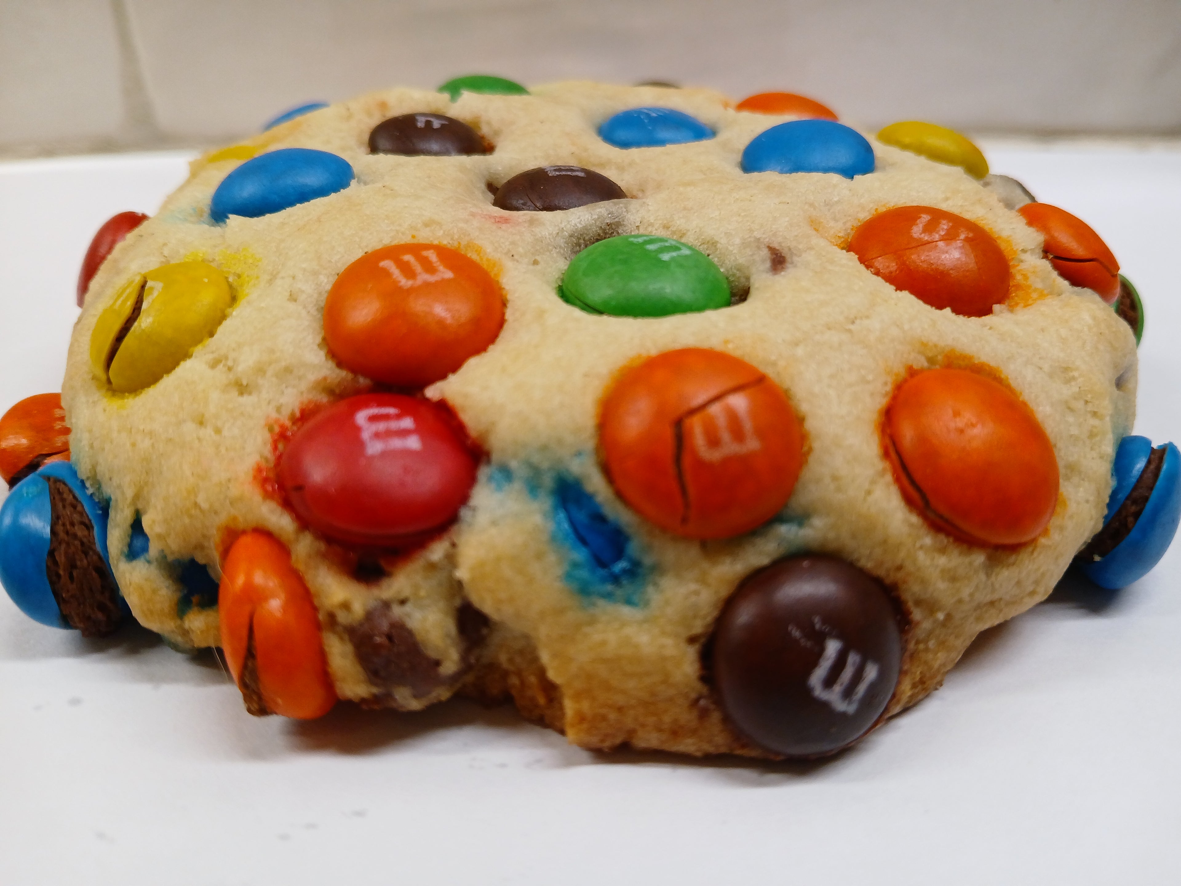 GF Cookie cake with M&M candies on a white surface